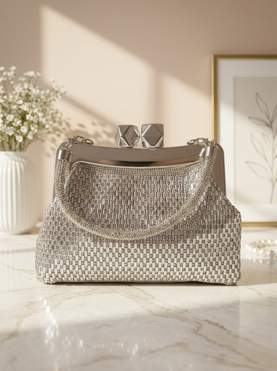 Crystal mesh frame clutch with silver weave and gold-toned geometric clasp