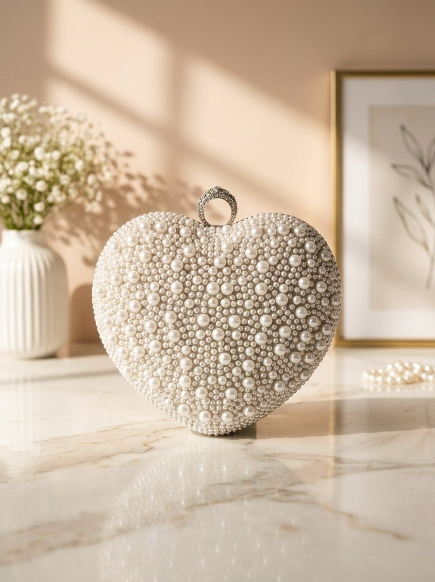 Heart-shaped pearl-embellished evening clutch with top loop handle