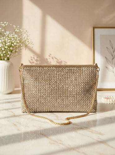 Gold crystal mesh envelope clutch, flat front with chain strap and magnetic closure.