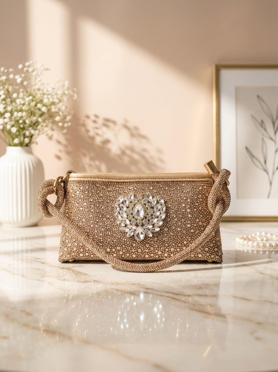 Gold crystal evening clutch with knot handles and crest front ornament