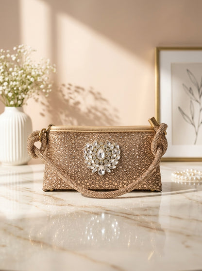Gold crystal evening clutch with knot handles and crest front ornament