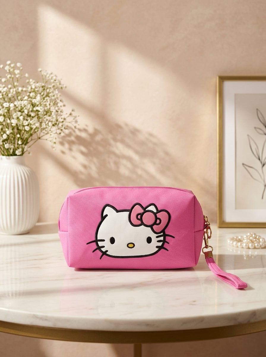 Hello Kitty canvas cosmetic pouch in hot pink, Hello Kitty face graphic and wrist strap