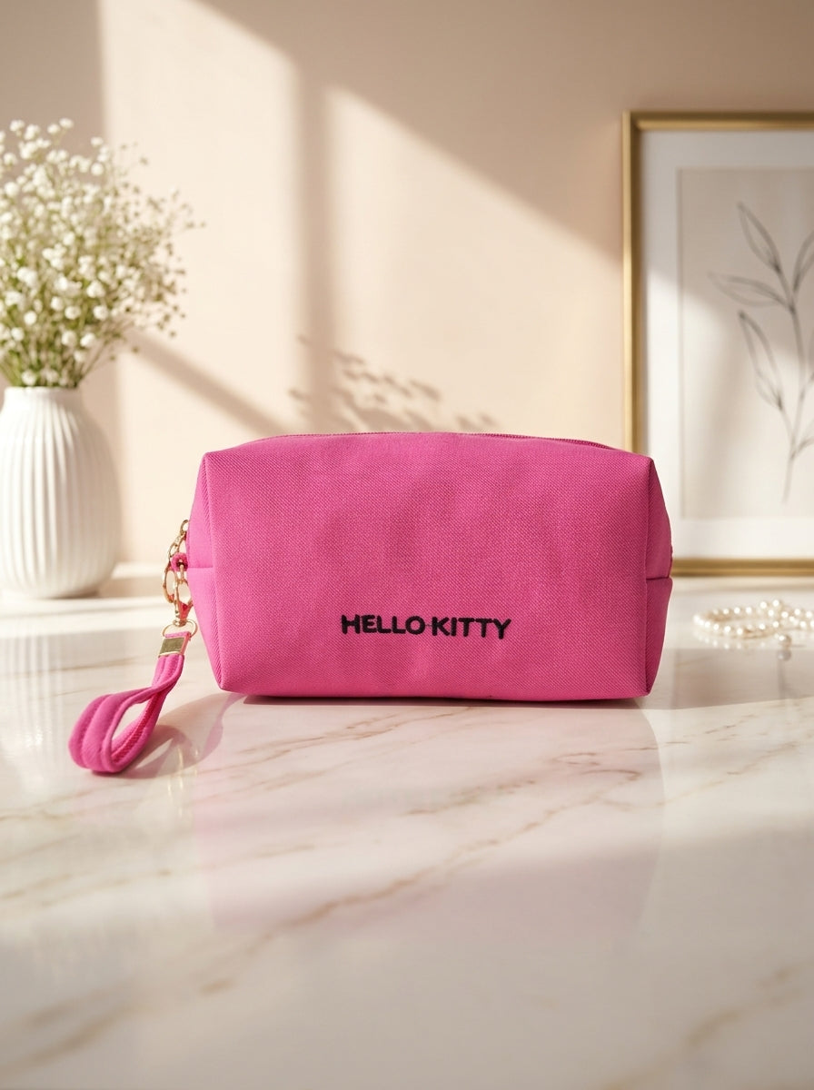Hello Kitty canvas cosmetic pouch in magenta, front text logo and zipper closure