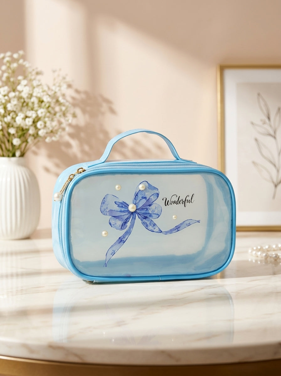 Blue transparent cosmetic pouch with blue floral bow ribbon print and gold zipper