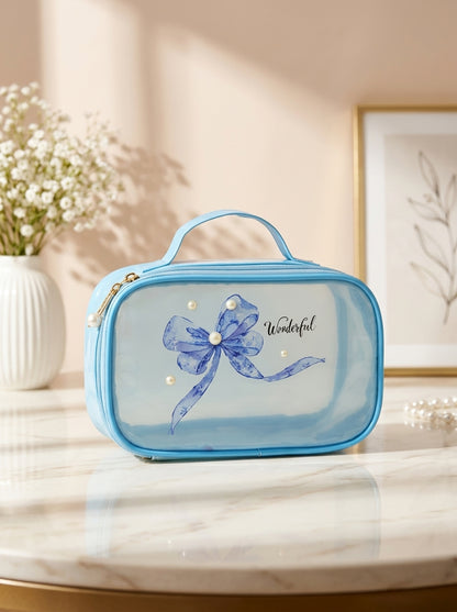 Blue transparent cosmetic pouch with blue floral bow ribbon print and gold zipper
