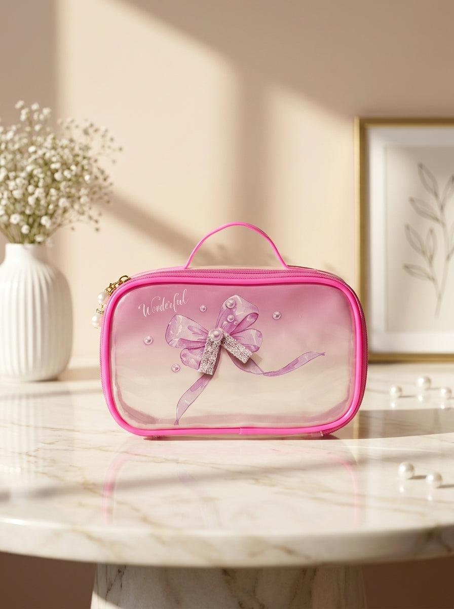 Magenta transparent cosmetic pouch with large bow ribbon print and gold zipper