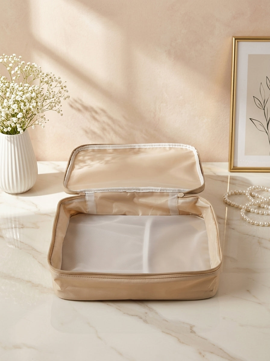 Beige waterproof travel beauty organizer with zip lid and mesh inner compartments
