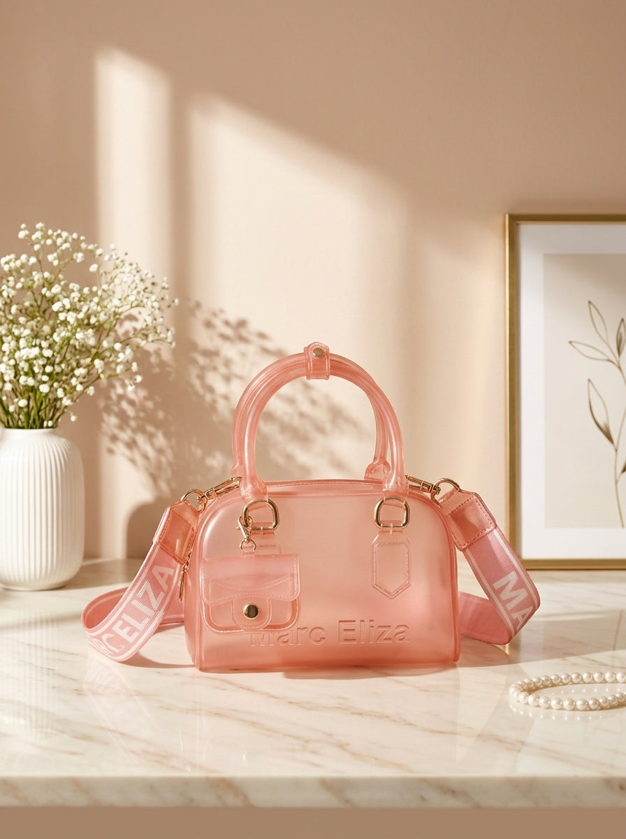 Peach jelly barrel handbag with top handles, zip closure, Marc Eliza logo, and strap.