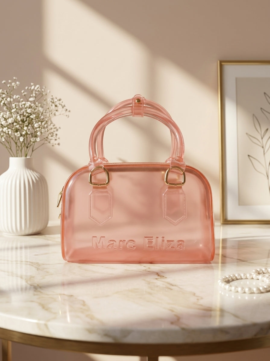 Pink jelly barrel handbag with top handles, zip closure, and Marc Eliza logo.