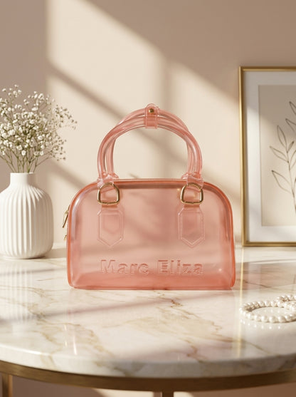 Pink jelly barrel handbag with top handles, zip closure, and Marc Eliza logo.