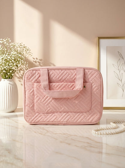 Pink quilted hanging toiletry organizer bag with top handle and front zip pocket