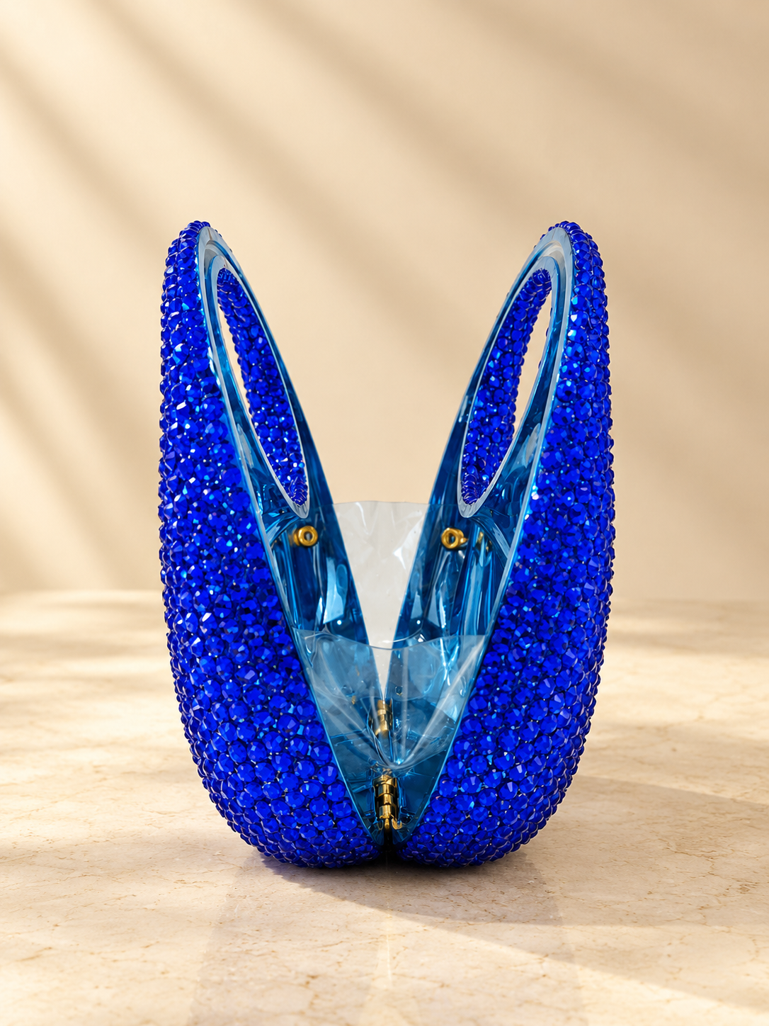 Blue crystal circular handbag with cut-glass style front and gold chain handles