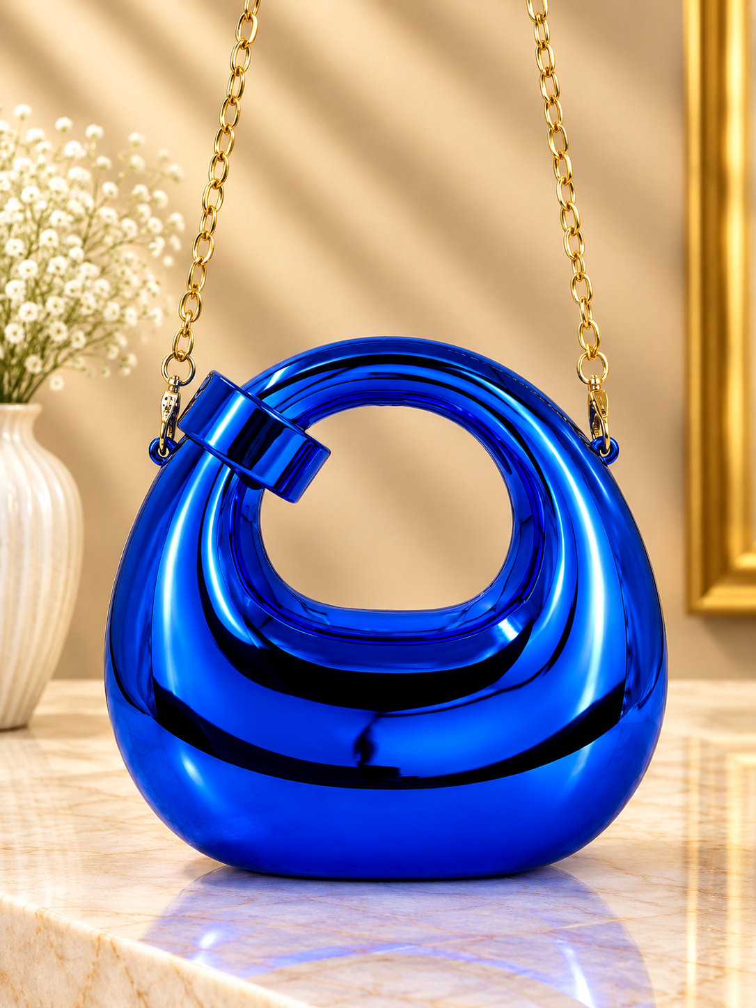 Blue metallic ring-loop evening handbag with chain strap and hinged handle