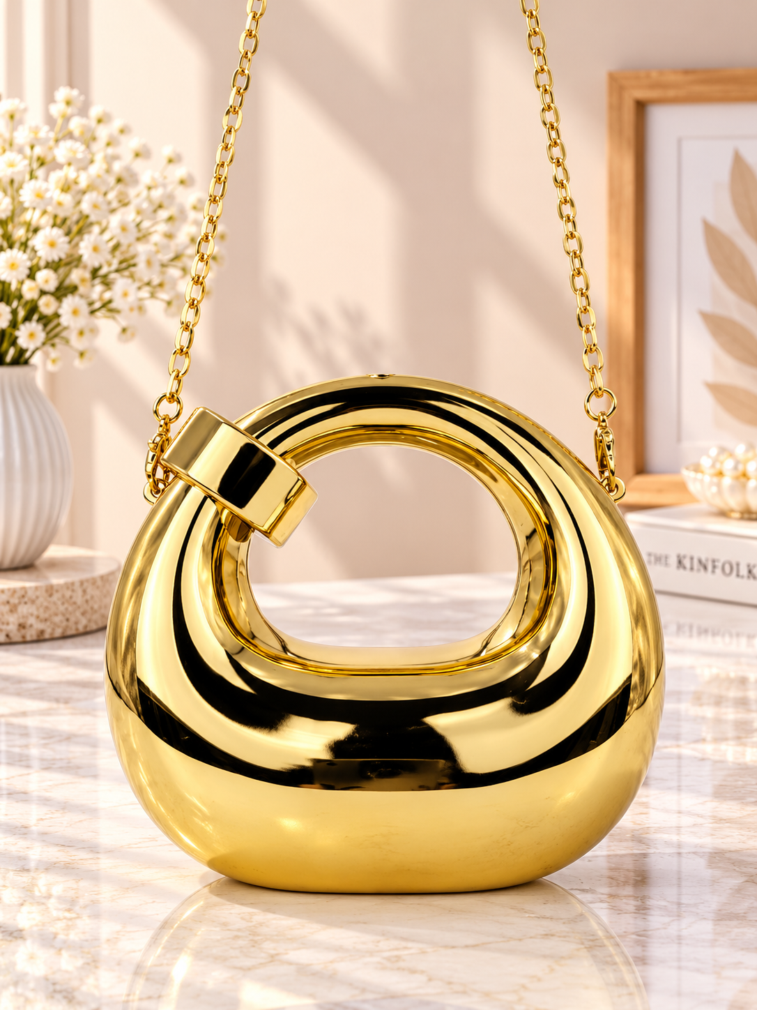 Gold metallic ring-loop evening handbag with short chain handles