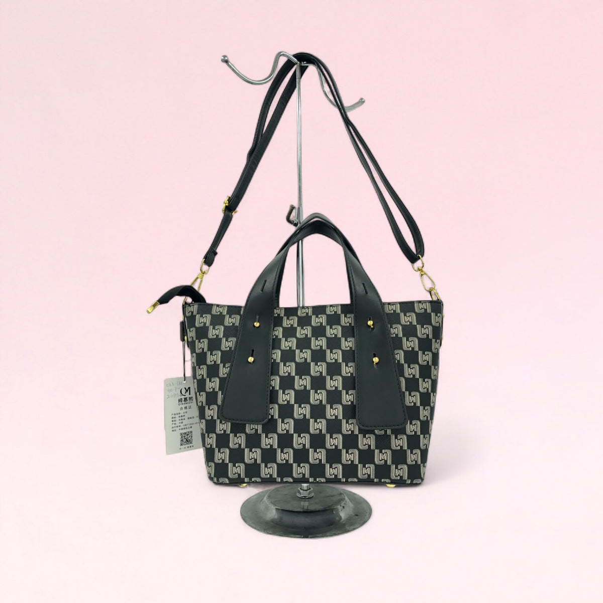 Black geometric monogram tote bag with matching pouch and top handles