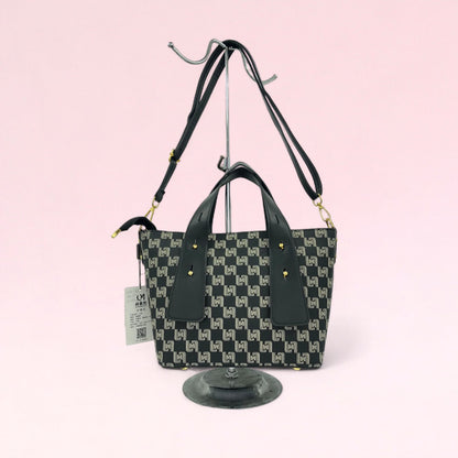 Black geometric monogram tote bag with matching pouch and top handles
