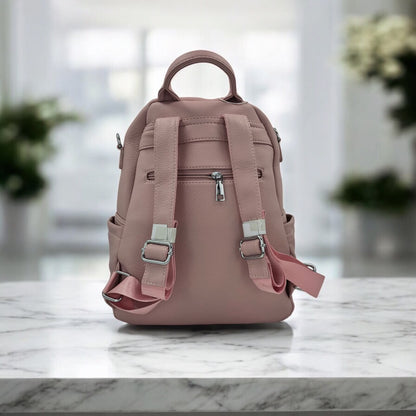 Dusty rose faux leather mini backpack with adjustable buckled straps and top carry handle
