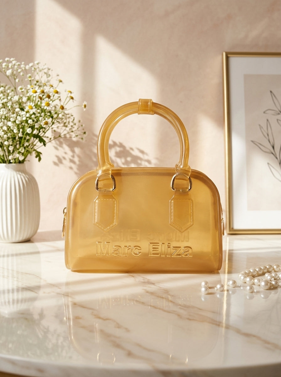 Yellow jelly barrel handbag with top handles, zip closure, and Marc Eliza logo.