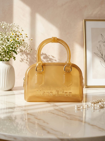 Yellow jelly barrel handbag with top handles, zip closure, and Marc Eliza logo.