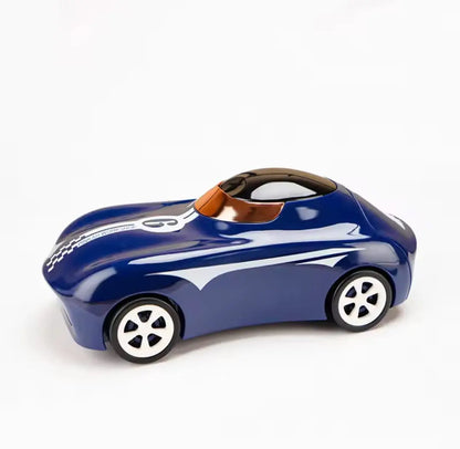 Blue car-shaped sipper bottle, side view with black lid