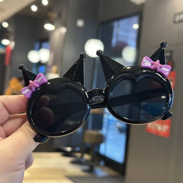 Kids' black crown sunglasses with purple bow and star accents, dark round lenses