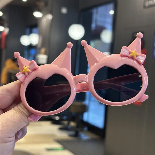Kids' pink crown sunglasses with bow-star charms and dark round lenses