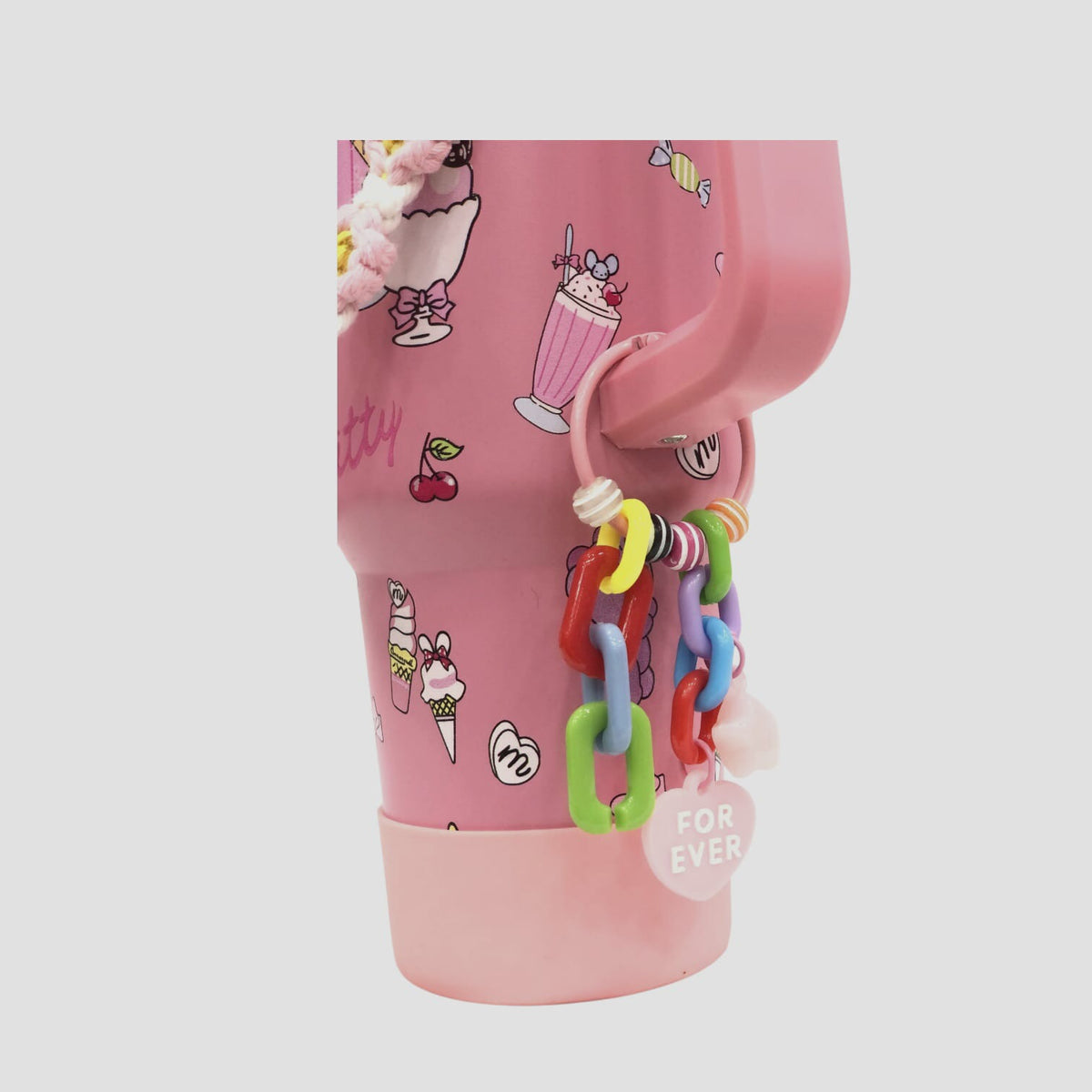 Pink character tumbler with colorful link keychain and all-over character pattern