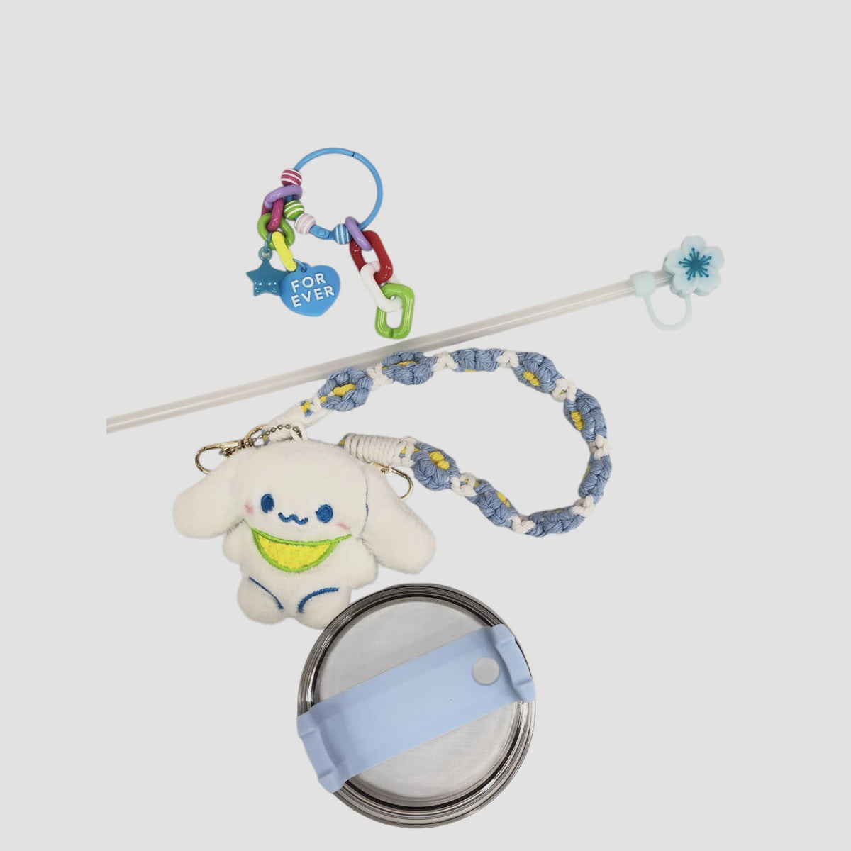 Light blue character tumbler with straw lid and braided strap with plush character