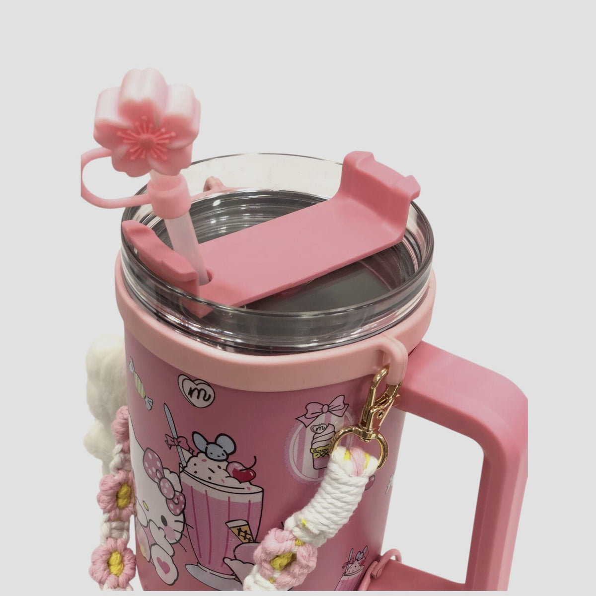 Pink character tumbler with clear metal rim, hinged lid, and plush braided charm