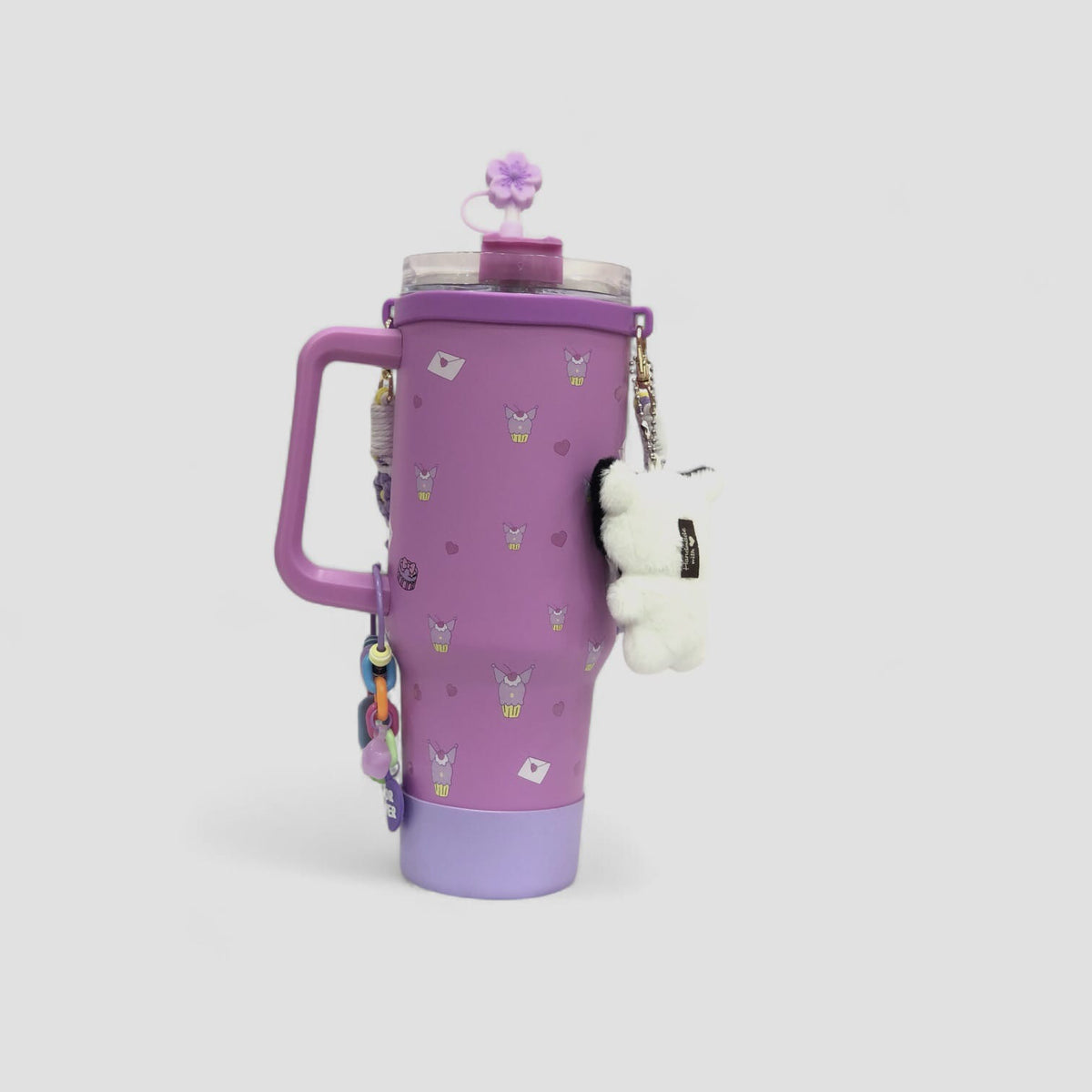 Purple character tumbler with handle, flip lid, dangling charm strap and plush