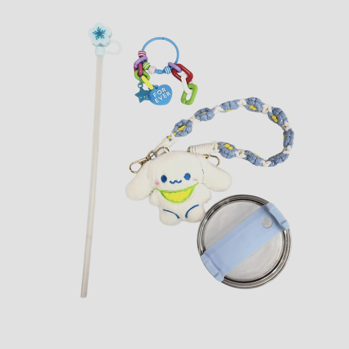 Light blue character tumbler with straw, plush charm, and braided wrist strap