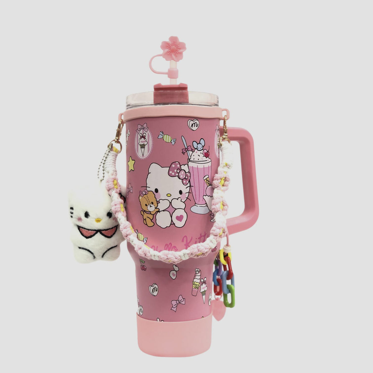 Pink character tumbler with mixed Sanrio graphics, handle, flip lid, dangling charms