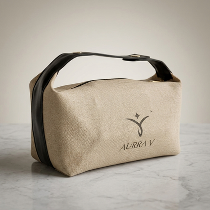 Beige canvas cosmetic pouch with black leather-look handles and front logo