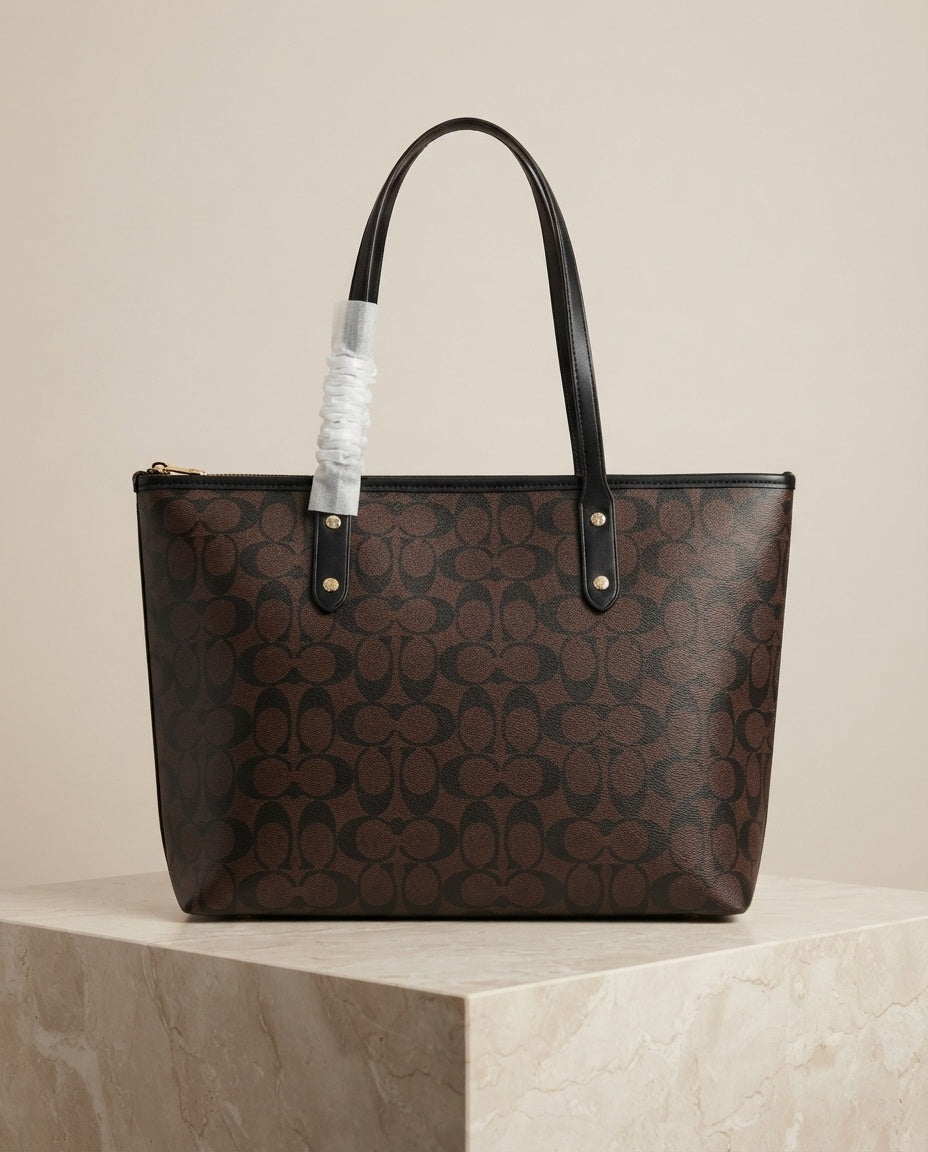 Dark brown monogram structured tote bag with black leather handles