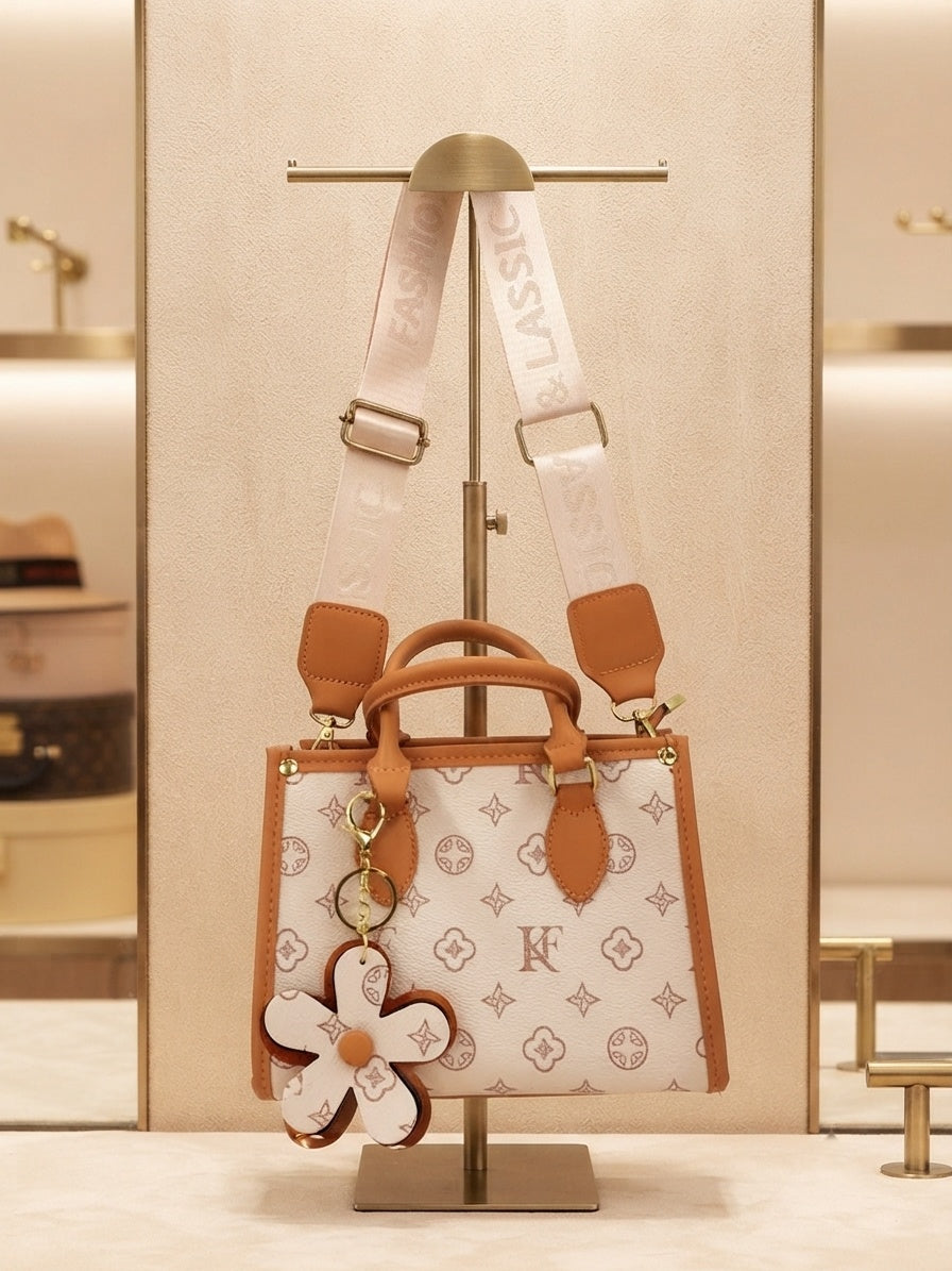 Monogram structured tote with crossbody strap and flower charm, white with tan accents