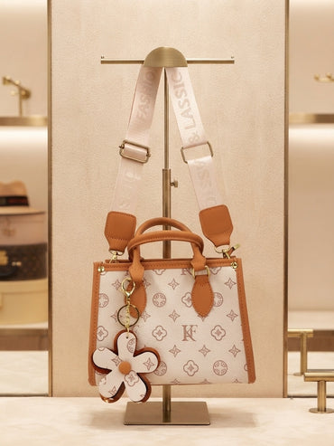 Monogram structured tote with crossbody strap and flower charm, white with tan accents