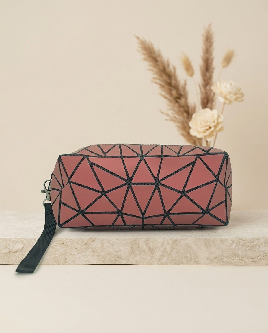 Geometric luminous cosmetic pouch in pink with wristlet strap and zipper