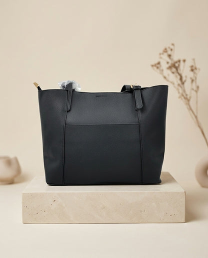 Black structured faux leather tote bag with top handles and front seam panel