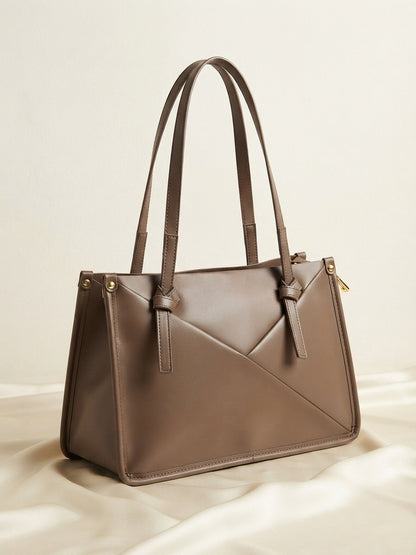 Knot-accent structured shoulder bag in taupe with short top handles and gold hardware
