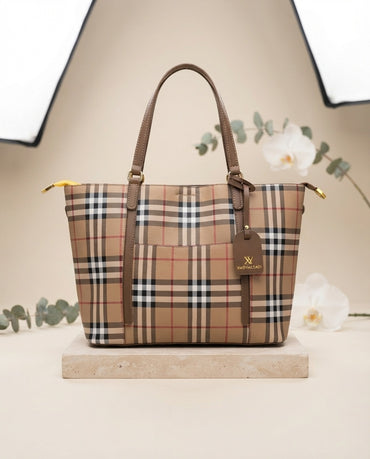 Beige plaid tote bag with brown handles and front charm detail