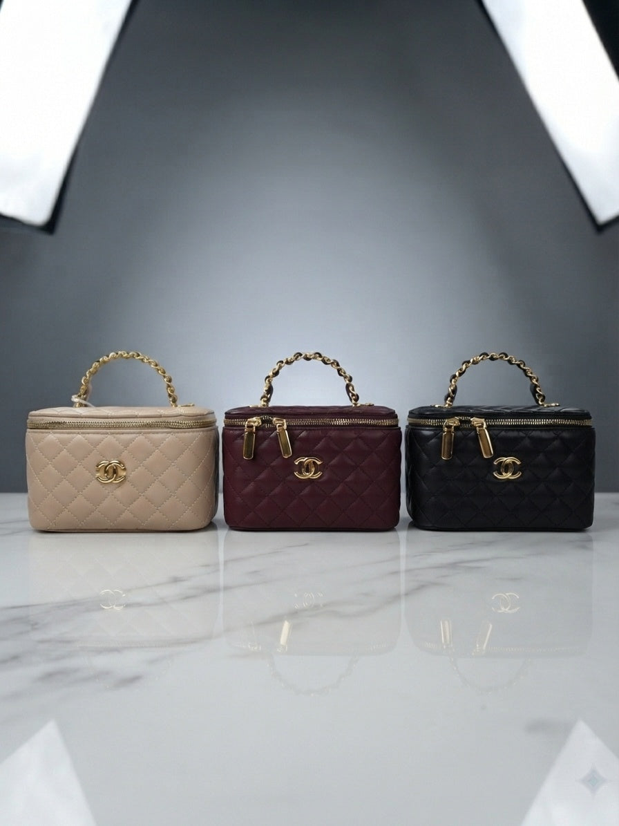 Three quilted vanity cosmetic cases with chain handles and interlocking CC logo: beige, maroon, black