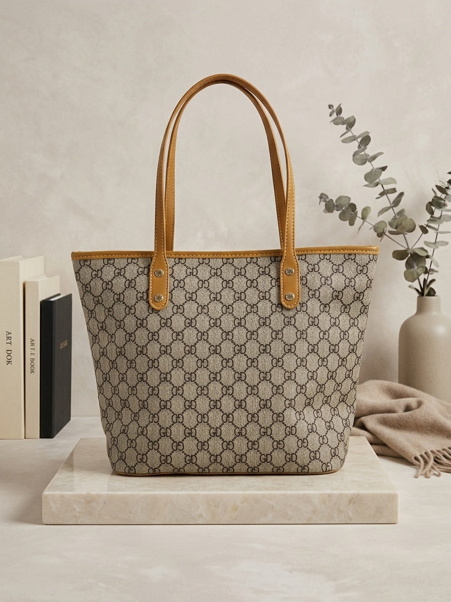 Monogram tote bag with beige-brown repeating pattern and tan leather handles
