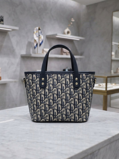 Structured monogram print tote bag with two top handles; navy and black accents