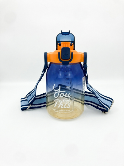 1L gradient water bottle in navy and orange with flip lid and shoulder strap.