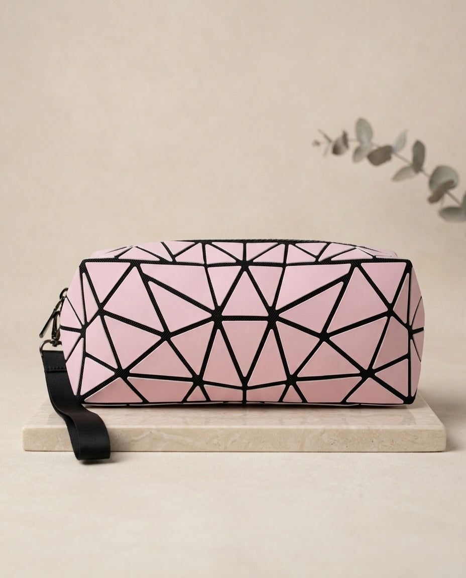 Pink geometric luminous cosmetic pouch with black zipper and wristlet strap