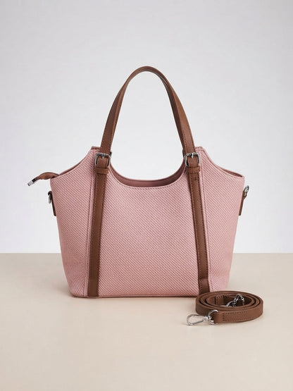 Structured pink top-handle handbag with scarf-style charm, front zipper, detachable crossbody strap