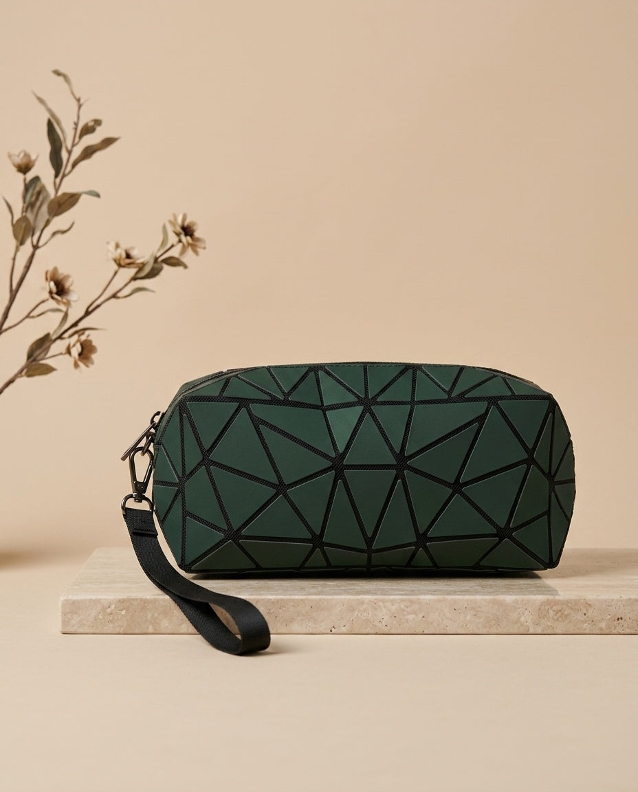 Geometric luminous cosmetic pouch in dark green with wristlet strap and zipper