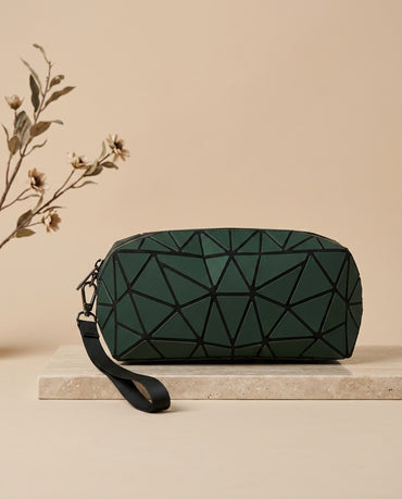 Geometric luminous cosmetic pouch in dark green with wristlet strap and zipper