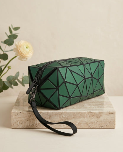Dark green geometric cosmetic pouch with wristlet strap, zipper and chain detail
