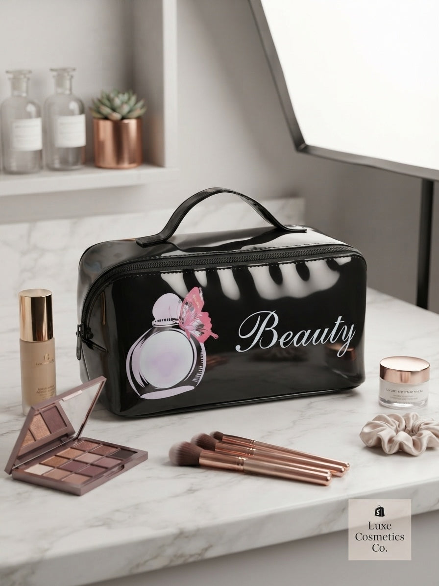 Black cosmetic bag with top handle, 'Beauty' text, and zipper closure.